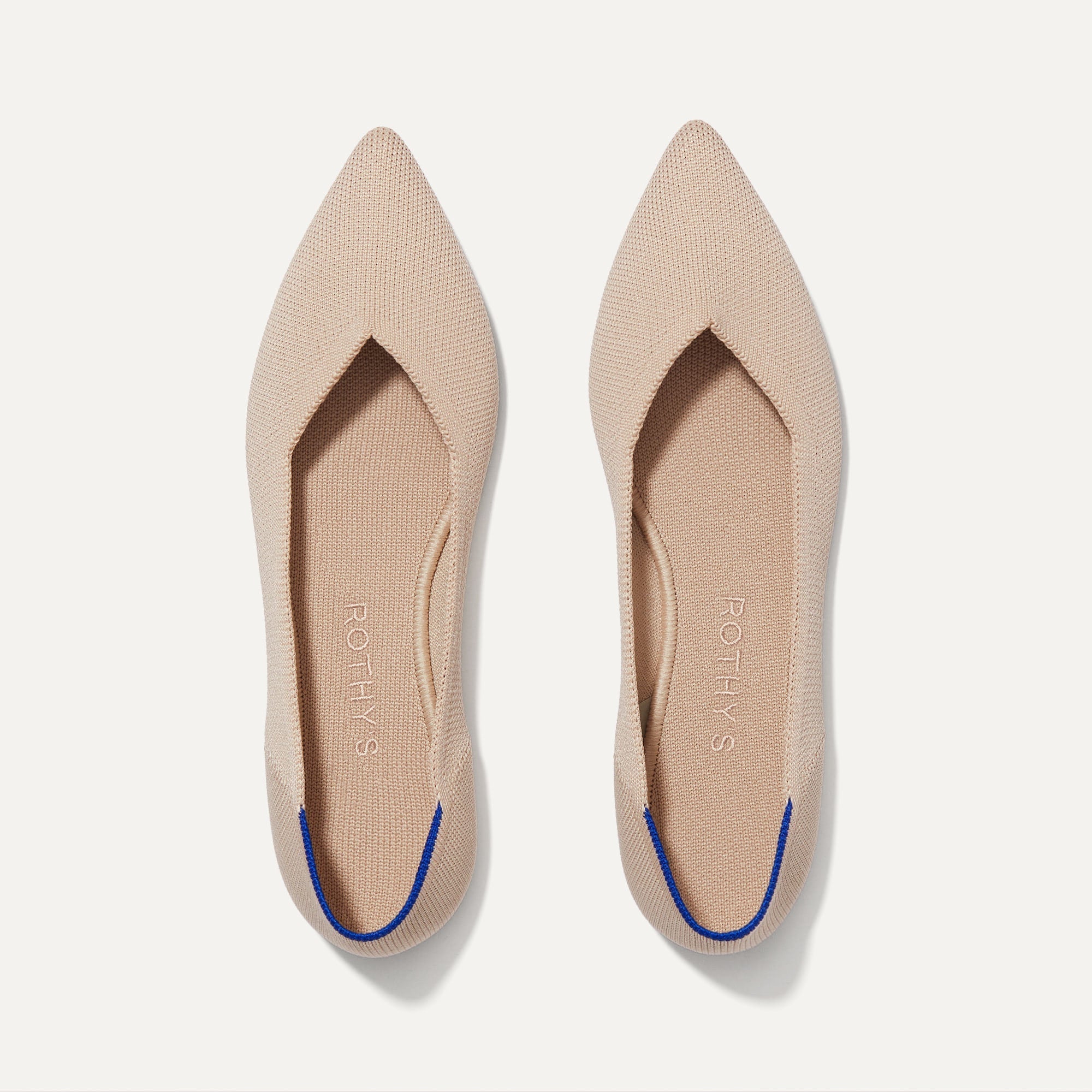 A pair of The Point shoe in Ecru shown from the top view.
