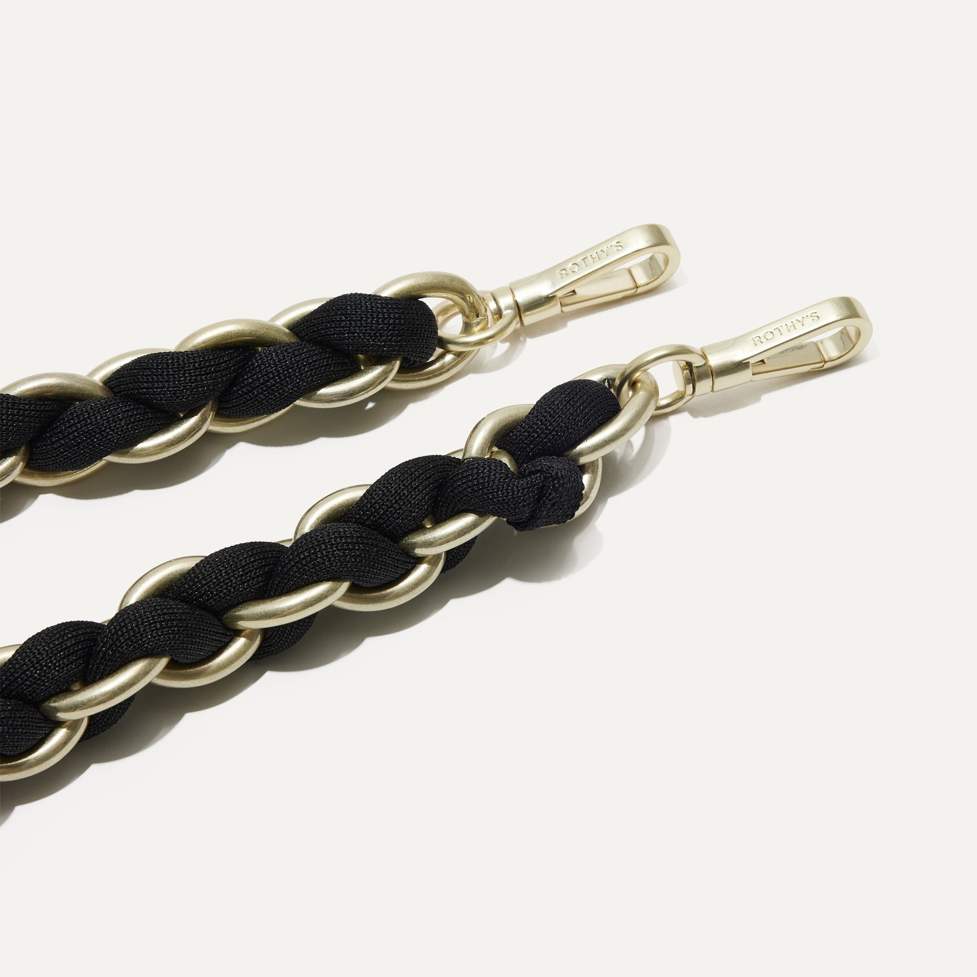 A close-up of The Shoulder Strap in Black, focusing on the end snap hooks. 