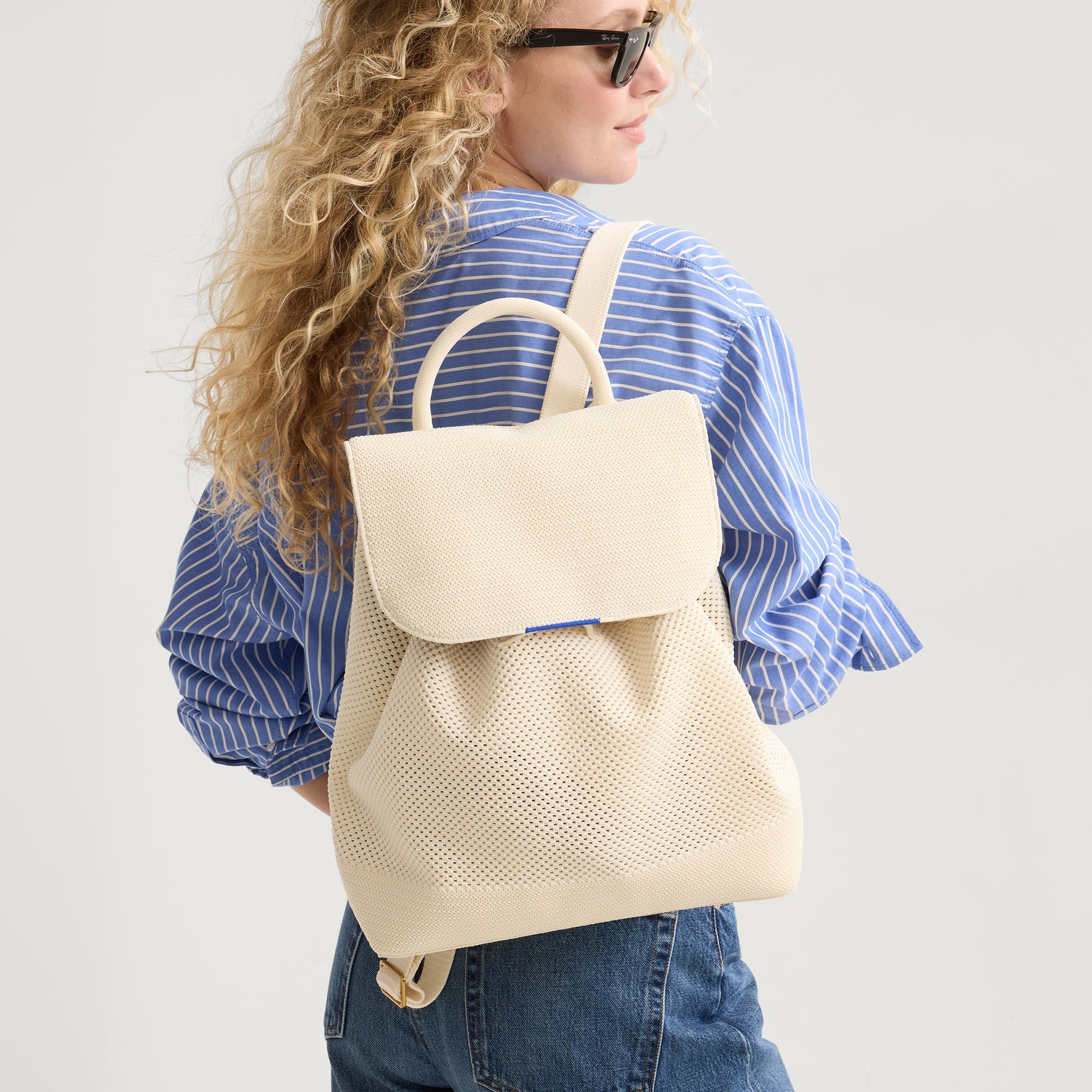 hover  | Model wearing The Cinch Backpack in Coconut Crochet. 
