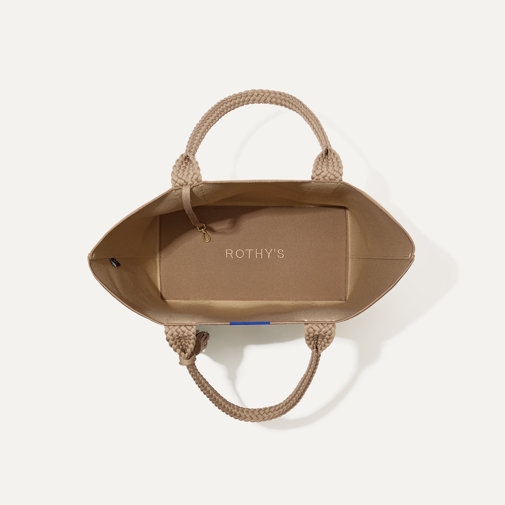 The Lightweight Tote in Caramel Twist shown open from the top, with interior visible. 