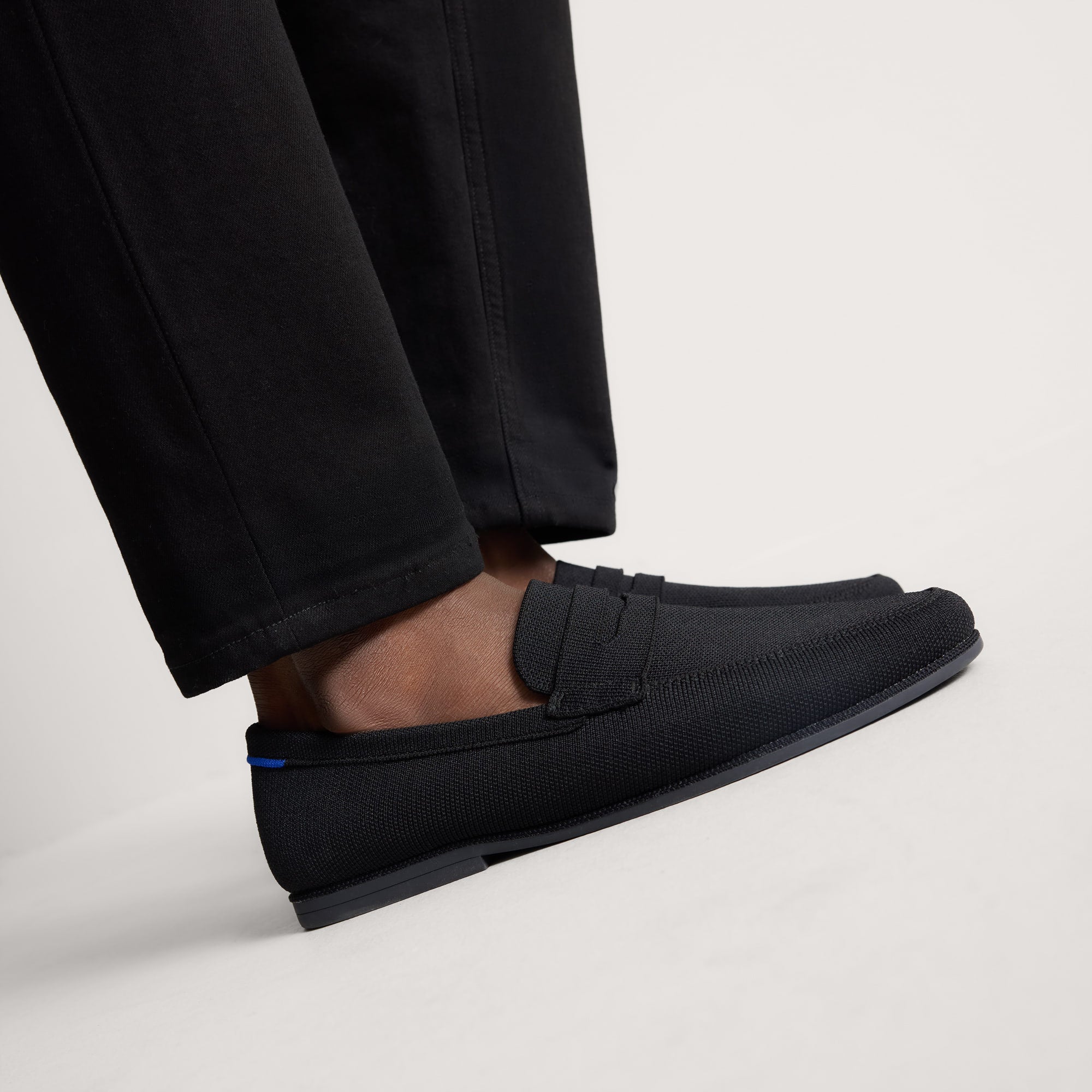 hover | Model wearing The Ravello Penny Loafer in Black. 