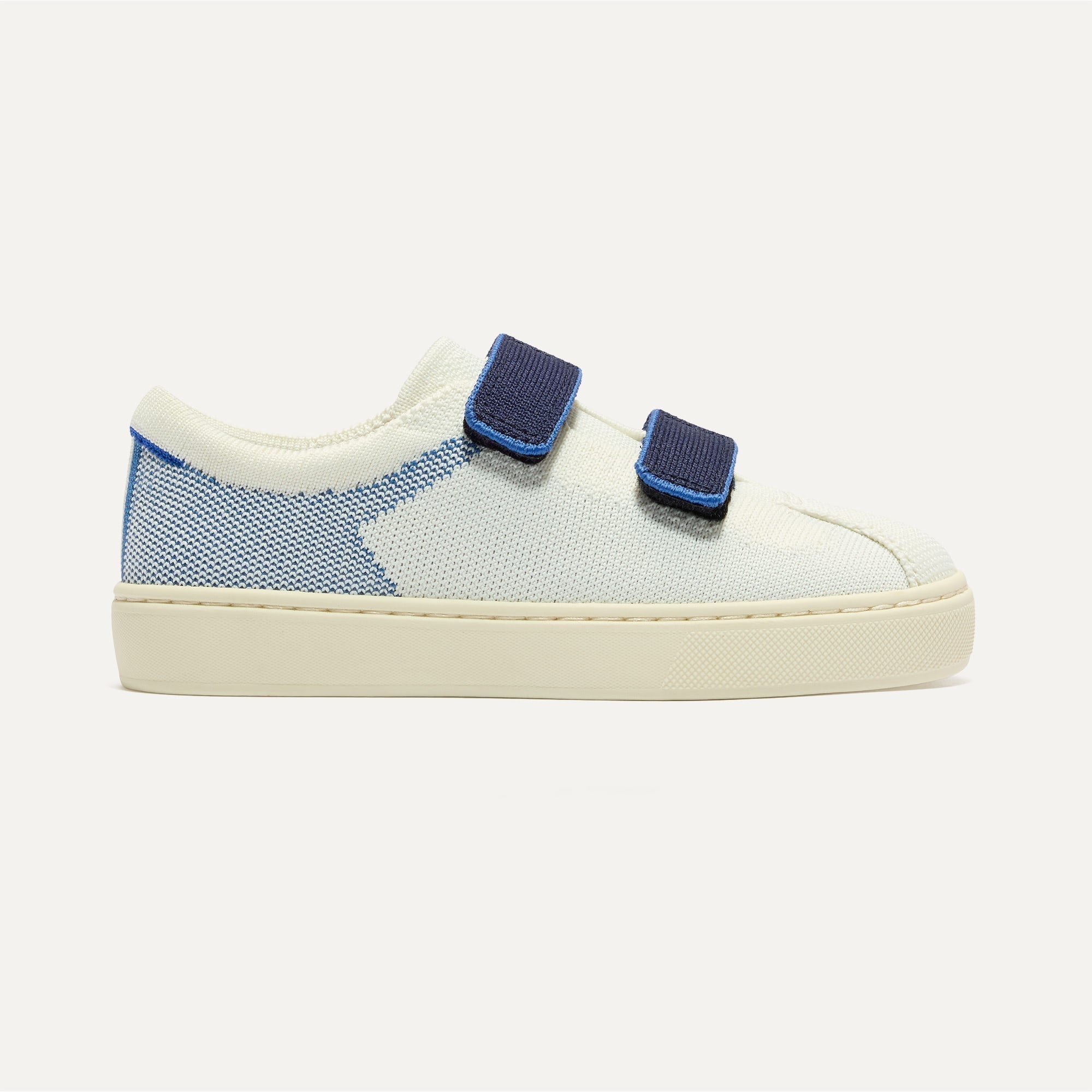 side | The Kids Strap Sneaker in Blue Raspberry shown from the side. 