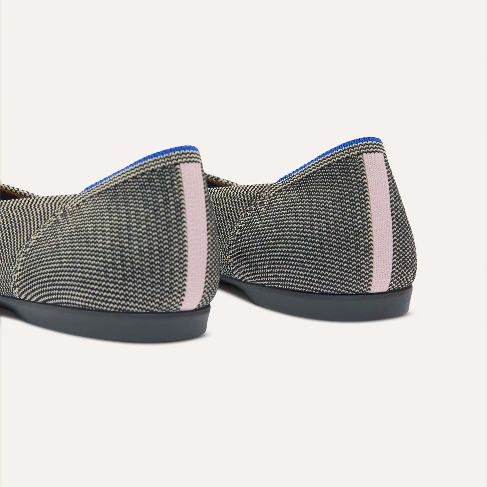 Close up of the heel of The Daily Flat in Salt Air, with Rothy's signature blue halo. 