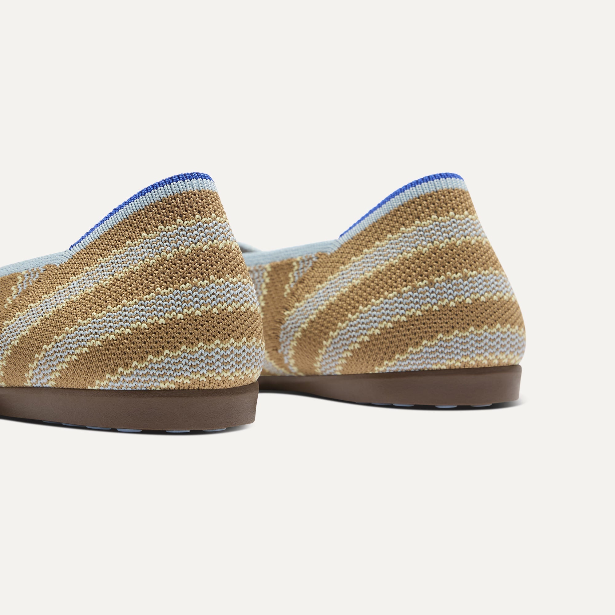 Close up of the heel of The Daily Flat in Terra Stripe, with Rothy's signature blue halo. 