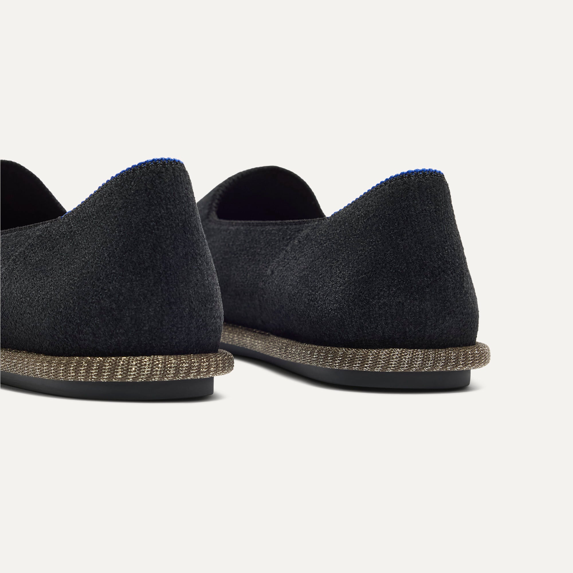 Close up of the heel of The Cruiser Loafer in ReVelvet Black, with Rothy's signature blue halo. 