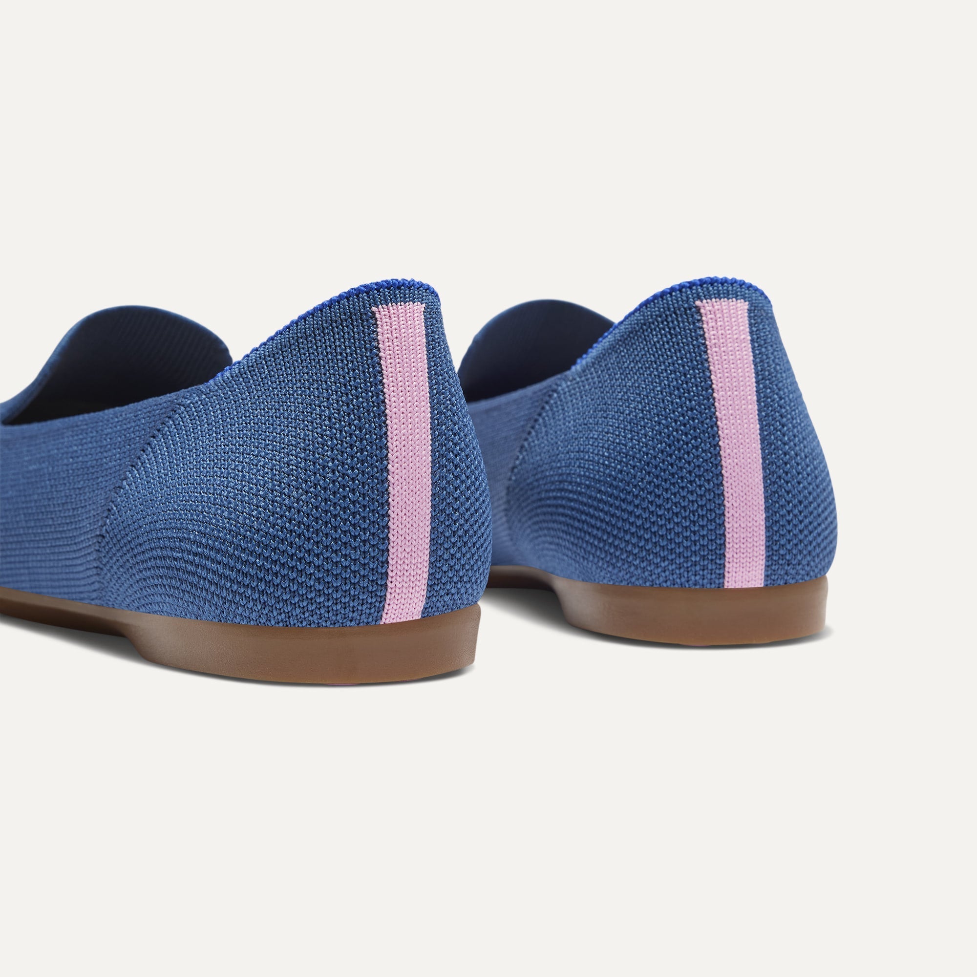 Close up of the heel of The Daily Loafer in Blue Trench, with raised peg outsoles and Rothy's signature blue halo. 