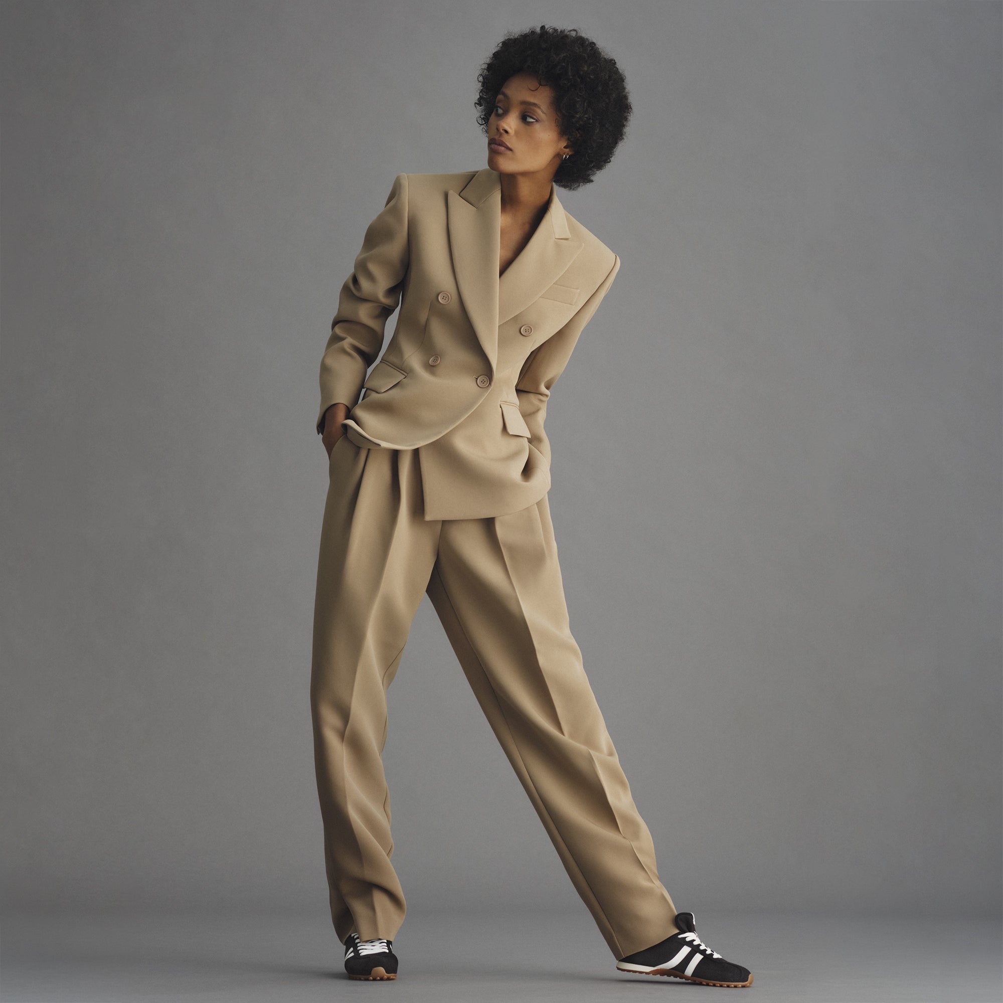 model | Alternate view of a model wearing The Ivy Sneaker in ReVelvet Black. 