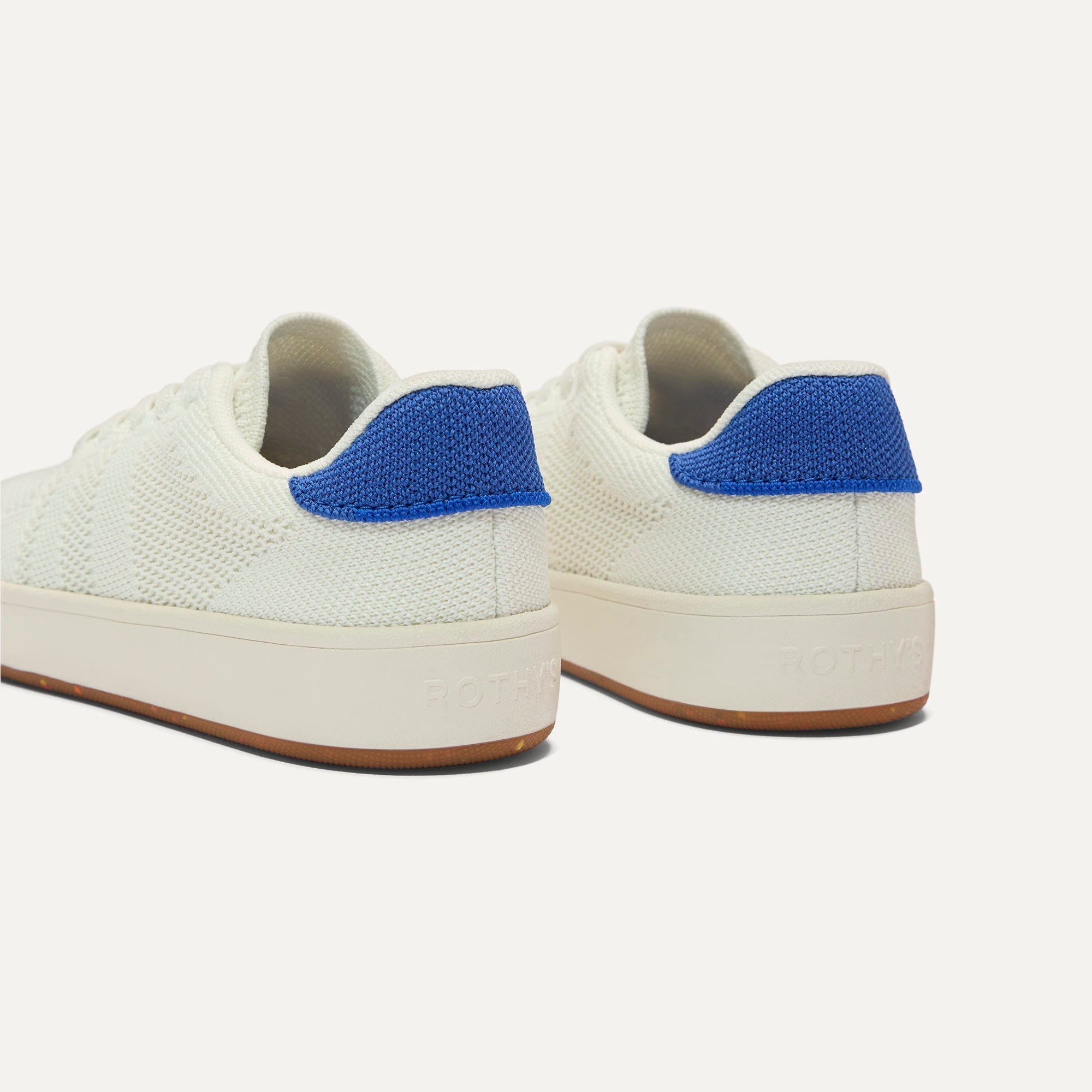 Close up of the heel of The Kids Stretch Sneaker in Turbo, with Rothy's signature blue halo. 
