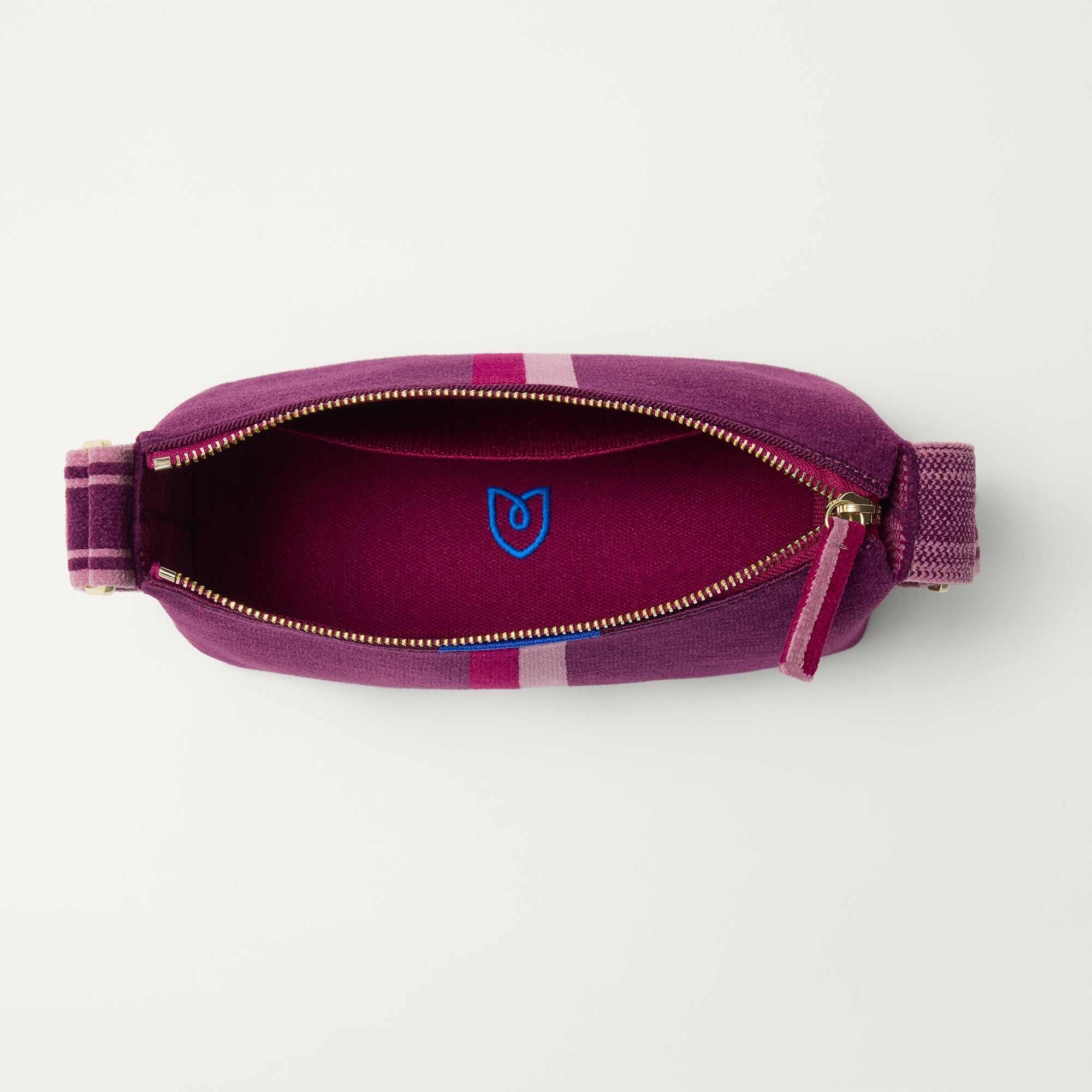 The Casual Crossbody in ReVelvet Orchid, shown from above, with the interior exposed. 